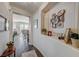 Bright hallway showcasing a decorative niche with Gathering photos and dark wood floors at 2555 Hampton Rd # 5104, Henderson, NV 89052