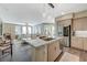 Open-concept kitchen with an island, stainless steel appliances, and adjacent living area at 2555 Hampton Rd # 5104, Henderson, NV 89052