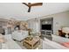 Open-concept living room with built-in shelving, a cozy fireplace, and access to the kitchen at 2555 Hampton Rd # 5104, Henderson, NV 89052
