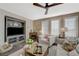 Spacious living room with a modern ceiling fan and lots of natural light from the large windows at 2555 Hampton Rd # 5104, Henderson, NV 89052