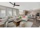 Bright living room featuring dark floors, neutral colors, plantation shutters, and access to the kitchen at 2555 Hampton Rd # 5104, Henderson, NV 89052