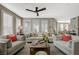 Comfortable living room with neutral colors, plantation shutters, dark wood floors, and modern ceiling fan at 2555 Hampton Rd # 5104, Henderson, NV 89052