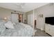 Comfortable main bedroom featuring a barn door, white ceiling fan, and calming decor at 2555 Hampton Rd # 5104, Henderson, NV 89052