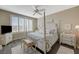Spacious main bedroom featuring a cozy four-poster bed, ceiling fan, and wood floors at 2555 Hampton Rd # 5104, Henderson, NV 89052