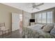 Bright bedroom with shuttered windows, ceiling fan and doorway to bathroom at 2555 Hampton Rd # 5104, Henderson, NV 89052