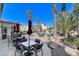 Inviting pool area with poolside tables, chairs, and palm trees under a bright sky at 2555 Hampton Rd # 5104, Henderson, NV 89052