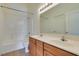Bathroom featuring double sinks, shower-tub, and large mirror at 2786 Fountain Ridge Ln, Henderson, NV 89074
