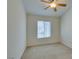 Bright bedroom featuring a ceiling fan, neutral carpet, and a window view at 2786 Fountain Ridge Ln, Henderson, NV 89074