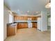 Well-equipped kitchen with tile floors, wood cabinets, granite countertops, and modern appliances for easy meal preparation at 2786 Fountain Ridge Ln, Henderson, NV 89074