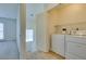 Convenient laundry room area with washer and dryer hookups, shelving, and storage space at 2786 Fountain Ridge Ln, Henderson, NV 89074