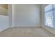 Spacious living room with a high ceiling, neutral carpet, and a large window at 2786 Fountain Ridge Ln, Henderson, NV 89074