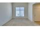 Bright room with neutral carpet, large window, and white door for a minimalist aesthetic at 2786 Fountain Ridge Ln, Henderson, NV 89074