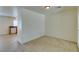 Open living space with carpet, wall and adjoining kitchen featuring granite counters at 2786 Fountain Ridge Ln, Henderson, NV 89074