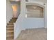 Open-concept living area with carpet, neutral walls, stairs and an arched entry at 2786 Fountain Ridge Ln, Henderson, NV 89074