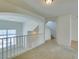 Bright loft space featuring an archway and white railing, offering a view of the downstairs area and natural light at 2786 Fountain Ridge Ln, Henderson, NV 89074