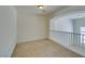 Spacious loft area with neutral carpet and white railing overlooking the lower level, perfect for a home office or play area at 2786 Fountain Ridge Ln, Henderson, NV 89074