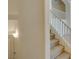 Bright staircase featuring white railings, neutral carpet, and a modern wall sconce at 2786 Fountain Ridge Ln, Henderson, NV 89074