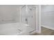 Bathtub and glass shower in a well lit primary bathroom at 2925 Wigwam Pkwy # 1021, Henderson, NV 89074