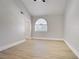 This bedroom offers ample space and natural light from a unique arched window with blinds at 2925 Wigwam Pkwy # 1021, Henderson, NV 89074