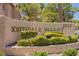 Entrance to Scottsdale Valley, surrounded by lush landscaping and mature trees, invites visitors to a serene community at 2925 Wigwam Pkwy # 1021, Henderson, NV 89074