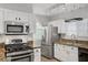 Modern kitchen featuring stainless steel appliances, granite countertops, and white cabinetry at 2925 Wigwam Pkwy # 1021, Henderson, NV 89074