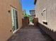 Private brick-paved backyard with gate access offers a cozy outdoor space at 3165 Beltrada Ave, Henderson, NV 89044
