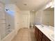 Bright bathroom featuring a tub-shower combo, vanity with double sinks, and tile flooring at 3165 Beltrada Ave, Henderson, NV 89044