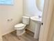 Powder room includes a pedestal sink, modern toilet and attractive flooring at 3165 Beltrada Ave, Henderson, NV 89044