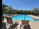 Inviting community pool area with comfortable lounge chairs, perfect for relaxation and enjoying the outdoors at 3165 Beltrada Ave, Henderson, NV 89044