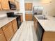 Well-lit kitchen with stainless steel appliances, spacious countertop and wooden cabinetry at 3165 Beltrada Ave, Henderson, NV 89044
