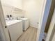 Neat laundry room featuring a washing machine and dryer, plus overhead shelf at 3165 Beltrada Ave, Henderson, NV 89044