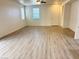 Spacious, bright living room with wood-style flooring, ceiling fan and multiple windows at 3165 Beltrada Ave, Henderson, NV 89044