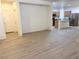 Open-concept living area with wood-style flooring leading into kitchen space at 3165 Beltrada Ave, Henderson, NV 89044
