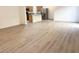 Open-concept living area with wood-style flooring leading into kitchen space at 3165 Beltrada Ave, Henderson, NV 89044