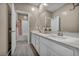 Elegant bathroom showcasing a double vanity with modern fixtures and a bright mirror reflecting the shower at 3195 Hazy Hills Ave, Henderson, NV 89052
