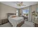 Cozy bedroom with decorative fan, large bed and a desk near the window at 3195 Hazy Hills Ave, Henderson, NV 89052