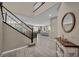 Welcoming entryway featuring stylish tile flooring, a staircase with dark wood accents, and an open view of the living area at 3195 Hazy Hills Ave, Henderson, NV 89052