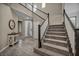 Grand entryway featuring tile floors, a staircase, and a decorative table adding a touch of elegance to the home's entrance at 3195 Hazy Hills Ave, Henderson, NV 89052