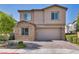Charming two-story home featuring brick accents, a paved driveway, and a well-maintained front yard with lush greenery at 3195 Hazy Hills Ave, Henderson, NV 89052