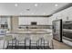 Spacious kitchen featuring an expansive island with seating, stainless steel appliances, and sleek white cabinetry at 3195 Hazy Hills Ave, Henderson, NV 89052