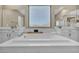 Close up of the soaking tub in a well-lit main bathroom with tiled floors at 3195 Hazy Hills Ave, Henderson, NV 89052