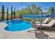Inviting backyard pool and spa area with stylish lounge seating and tropical mural, perfect for relaxation at 3195 Hazy Hills Ave, Henderson, NV 89052