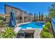 Inviting backyard showcasing a sparkling pool, a relaxing hot tub, and comfortable lounge seating, perfect for outdoor enjoyment at 3195 Hazy Hills Ave, Henderson, NV 89052
