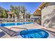 Inviting community pool and jacuzzi surrounded by lush landscaping at 3221 Jericho St # D, Las Vegas, NV 89102