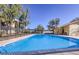 Large community pool area with mature trees and privacy fencing at 3221 Jericho St # D, Las Vegas, NV 89102