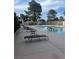 Community pool and lounge area with comfortable seating and lush greenery at 3226 Weber Ct, Las Vegas, NV 89121