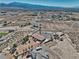 Aerial view of a single-story home in a desert landscape, surrounded by a fenced yard and native vegetation at 3251 S Parkridge Ave, Pahrump, NV 89048