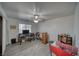 Bright bedroom featuring a ceiling fan, wood laminate flooring, and a window for natural light at 3251 S Parkridge Ave, Pahrump, NV 89048