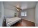 Bedroom with hardwood floors, ceiling fan, and closet with wire shelving, and ample natural light at 3251 S Parkridge Ave, Pahrump, NV 89048