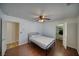 Bedroom with hardwood floors, ceiling fan, and closet with a wire shelving system, providing ample storage at 3251 S Parkridge Ave, Pahrump, NV 89048